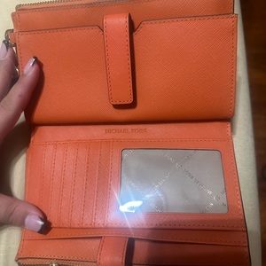 Orange Michael Kors wristlet